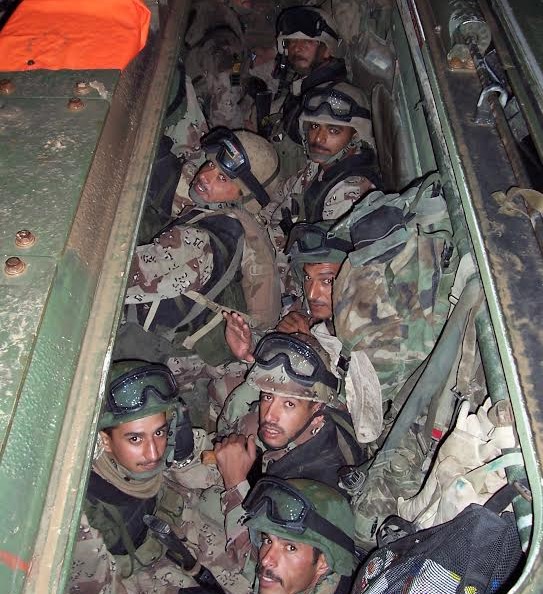 Soldiers from Fifth Battalion are packed into a Marine Corps amphibious assault vehicle minutes before the breach of Fallujah in November 2004.