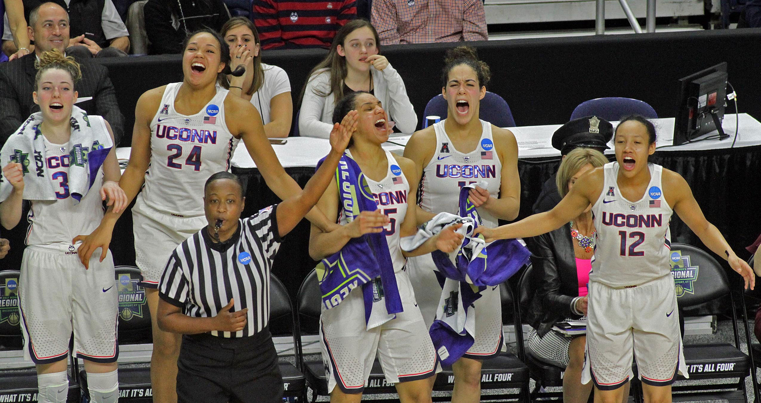 Group shot of UConn Women's Basketball team members cheering. From left:Katie Lou Samuelson ’19 (CLAS), Napheesa Collier ’19 (CLAS), Gabby Williams ’18 (CLAS), Kia Nurse ’18 (CLAS), and Saniya Chong ’17 (CLAS) cheer on teammates (not pictured) Molly Bent ’20 (ACES), Natalie Butler, Crystal Dangerfield ’20 (ACES), Kyla Irwin ’20 (CLAS), and Tierney Lawlor ’17 (CAHNR) during their Elite Eight defeat of Oregon.