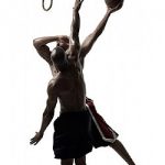 Two men playing one-on-one basketball. One man is shooting the basketball into a hanging noose as if it were a hoop