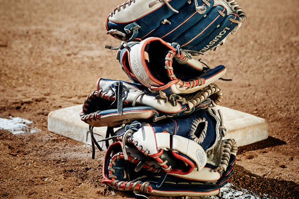 Stack of softball gloves on the field