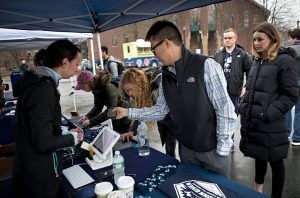 People giving at a donation table for UConn Gives