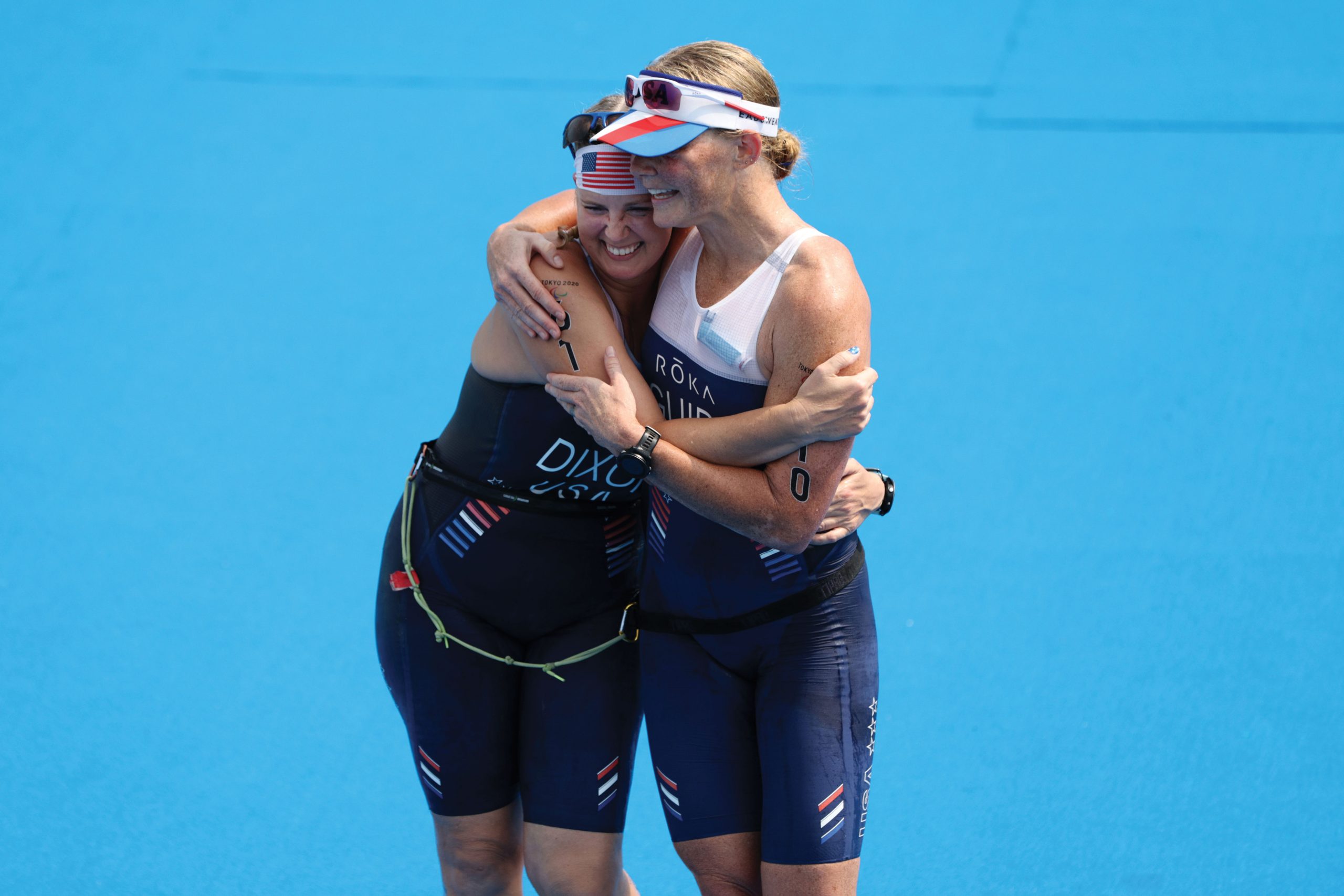 Amy Dixon and her guide Kirsten Sass hug after crossing the finish line in the 2020 Paralympic Games