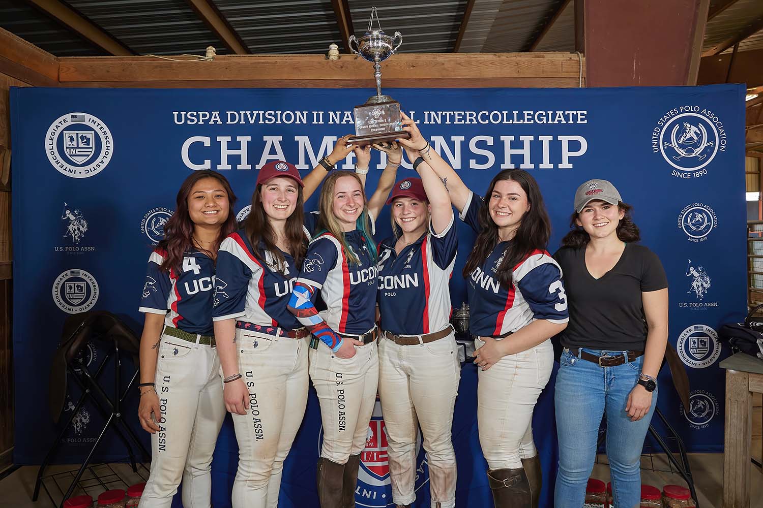 The Women's Polo Team posing with their championship trophy