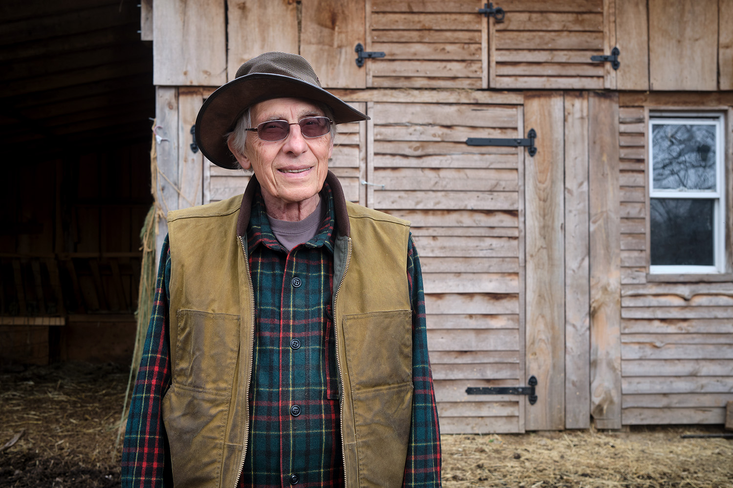 Frank Costigliola stands infront of a barn