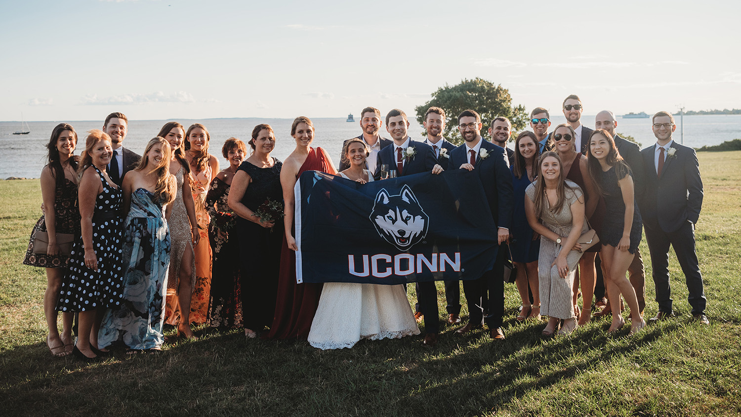 Sam Marshall wedding party holds UConn Huskies Flag