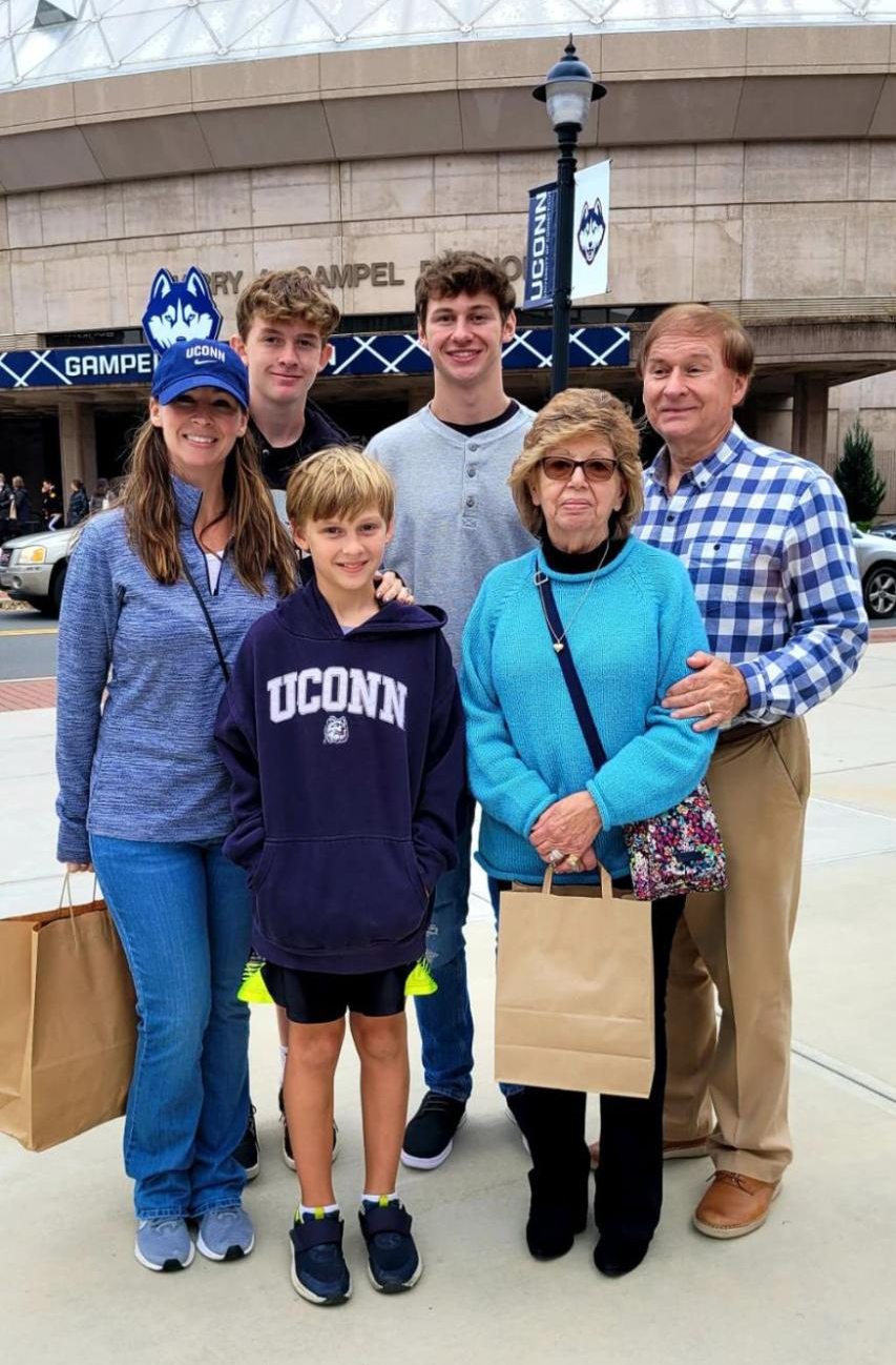 a three-generation Husky photo at Family Weekend 2021 with Angela, her son, and her father.