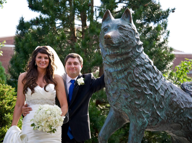 Richard Huntington and wife in wedding outfits by UConn's Jonathan statue
