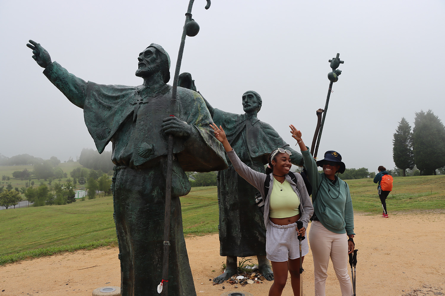 tourists and statues in similar poses
