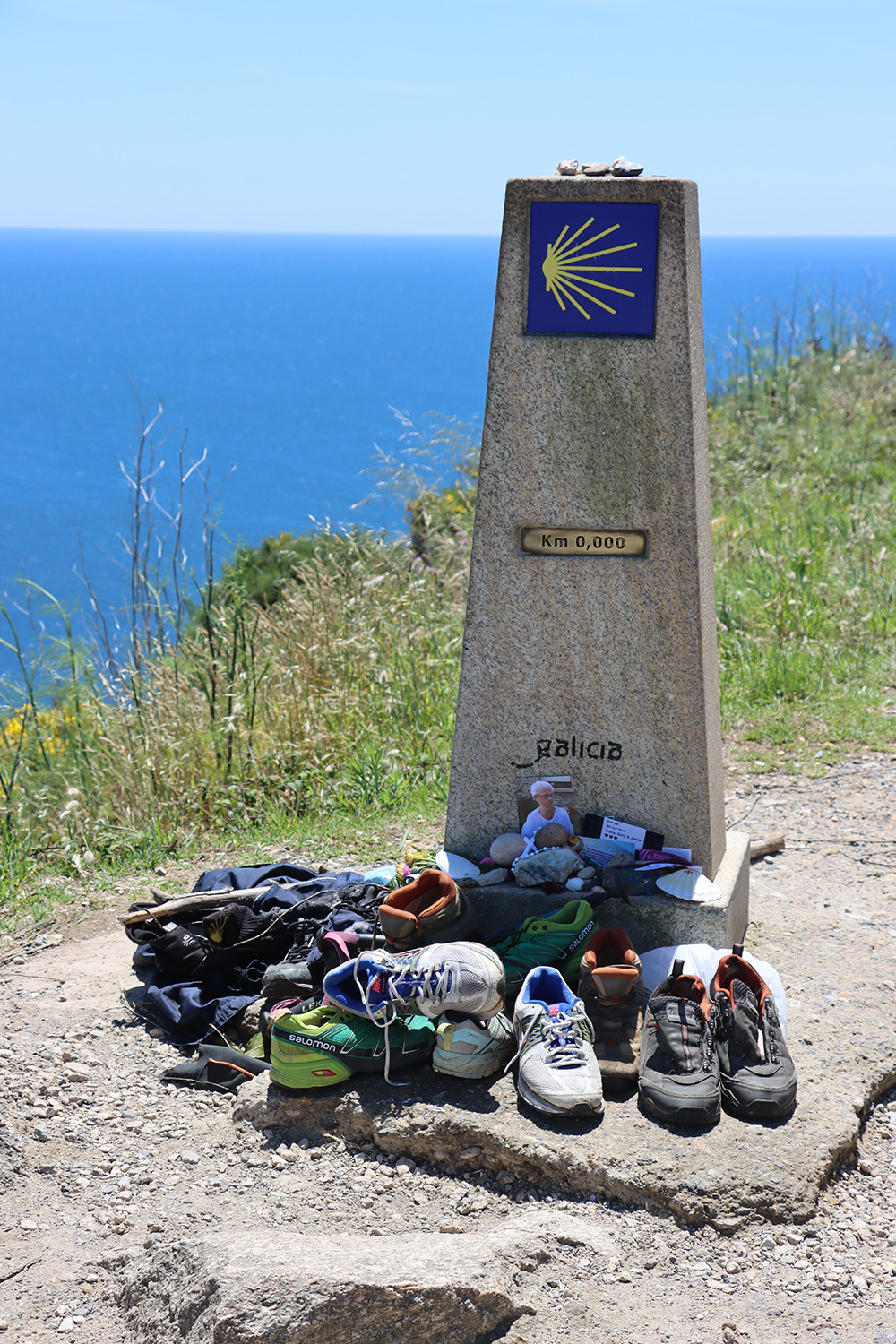 shoes and memorial items at a trail marker