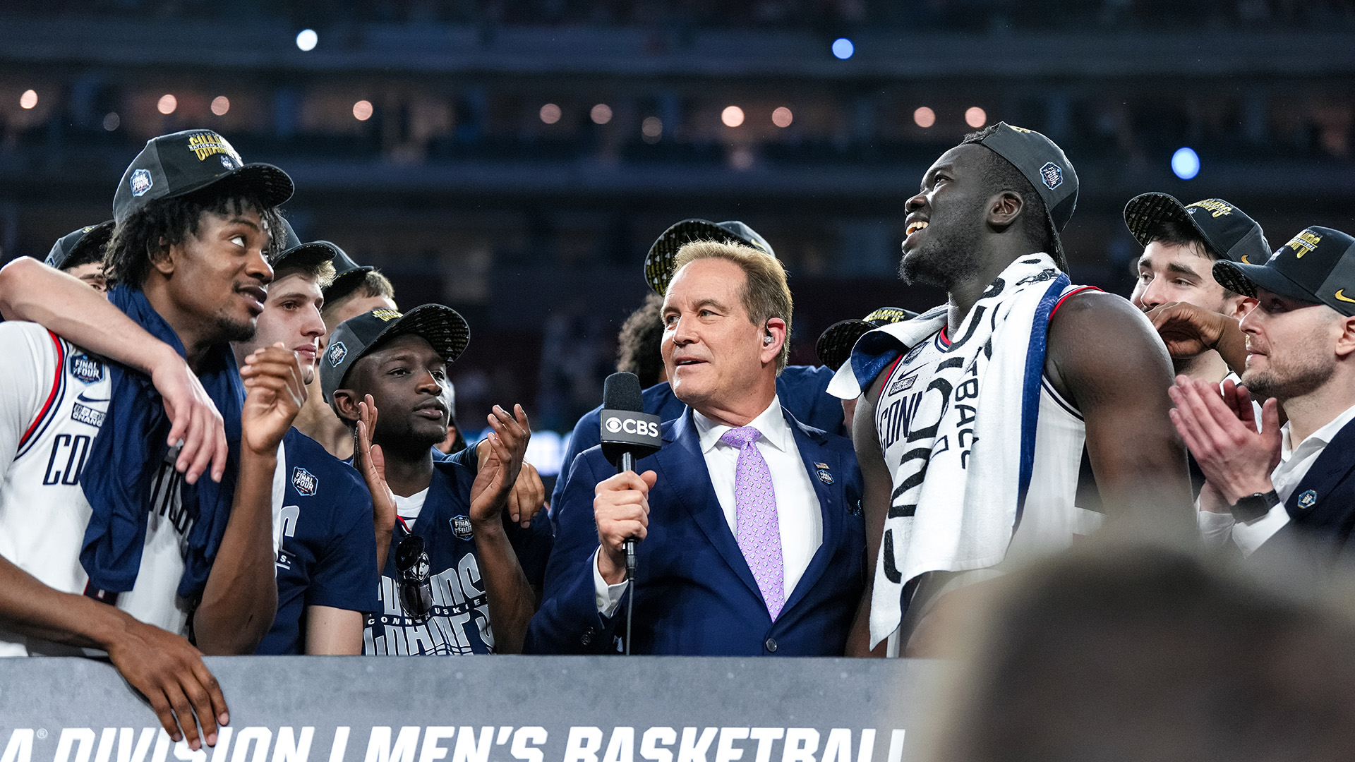 CBS Sports’ Jim Nantz interviews the UConn men's basketball team and 2023 champions during the Final Four.