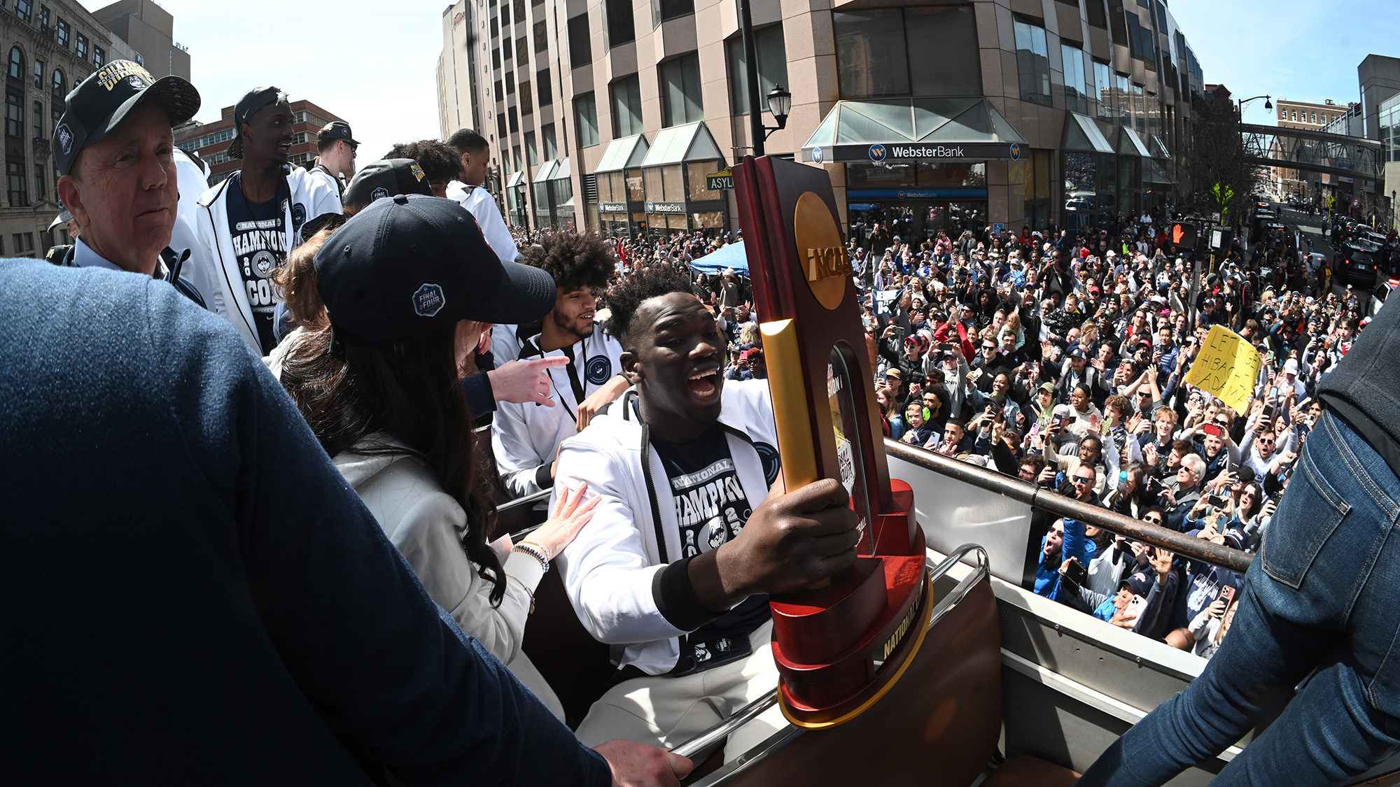 Adama Sanogo and Jackson Jr. celebrate during the parade held in hartford in honor of the 2023 championship game