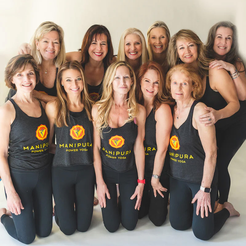 Pam Mead (bottom, center) with yoga teachers at her studio