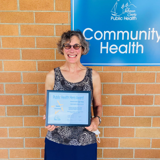 Sarah Grossman proudly shows her Public Health Hero Award