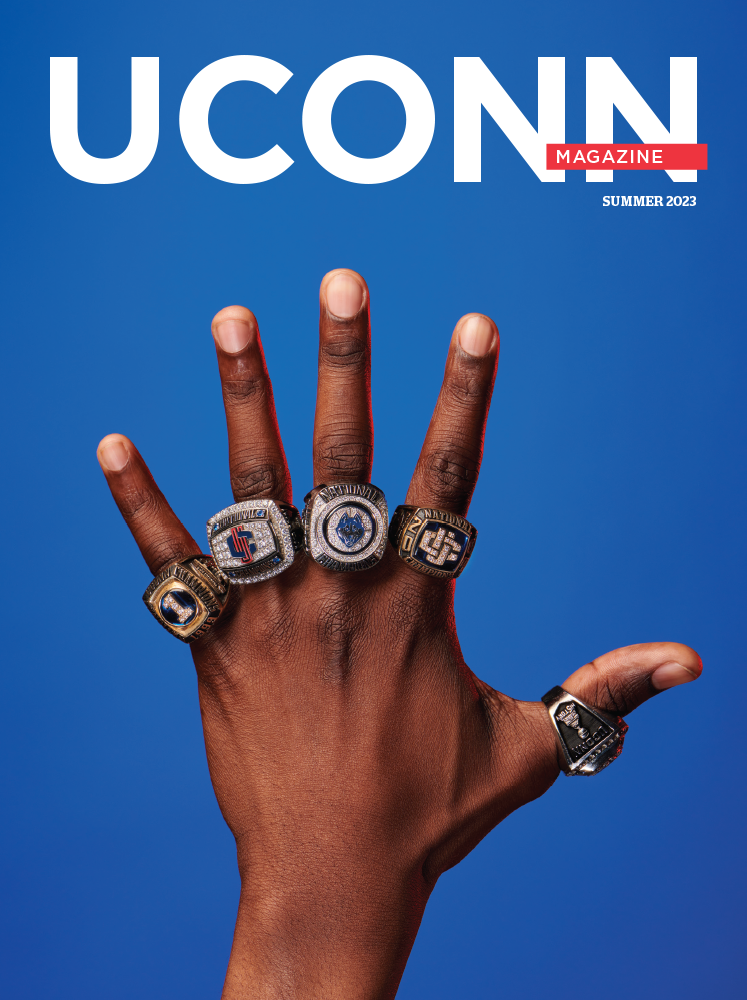 UConn Magazine cover featuring a photo of a hand wearing five UConn Men's Basketball championship rings, one for each finger.
