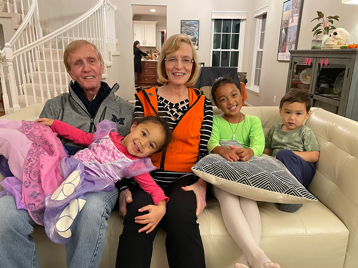 Phoebe (Leavenworth) and Ben Palmer share the couch with their 3 grand kids