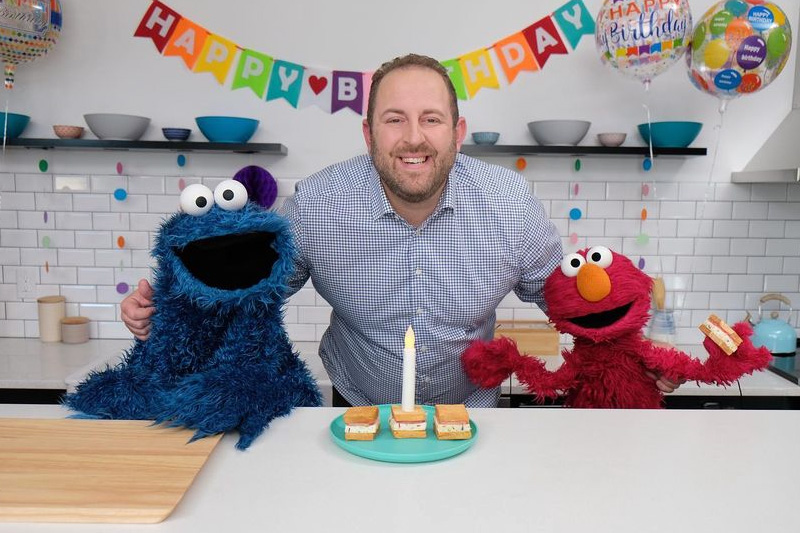 Joel Gamoran , Cookie Monster and Elmo pose with Confetti Ice Cream Sandwiches on “Sesame Street”