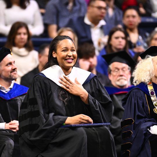 Maya Moore Irons smiles in her commencement regalia