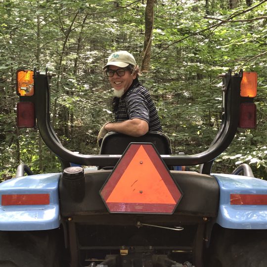 Dennis S. Main bush hogging trail on tractor