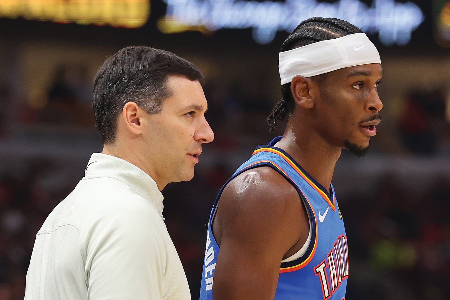 Head coach Mark Daigneault of the Oklahoma City Thunder talks with Shai Gilgeous-Alexander #2 against the Chicago Bulls during the second half at the United Center on October 25, 2023 in Chicago, Illinois.