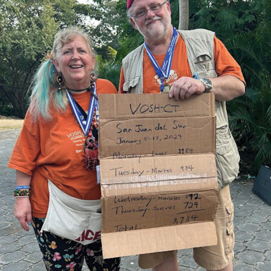 Matthew and Audrey Blondin pose holding a sign with VOSH-CT important dates