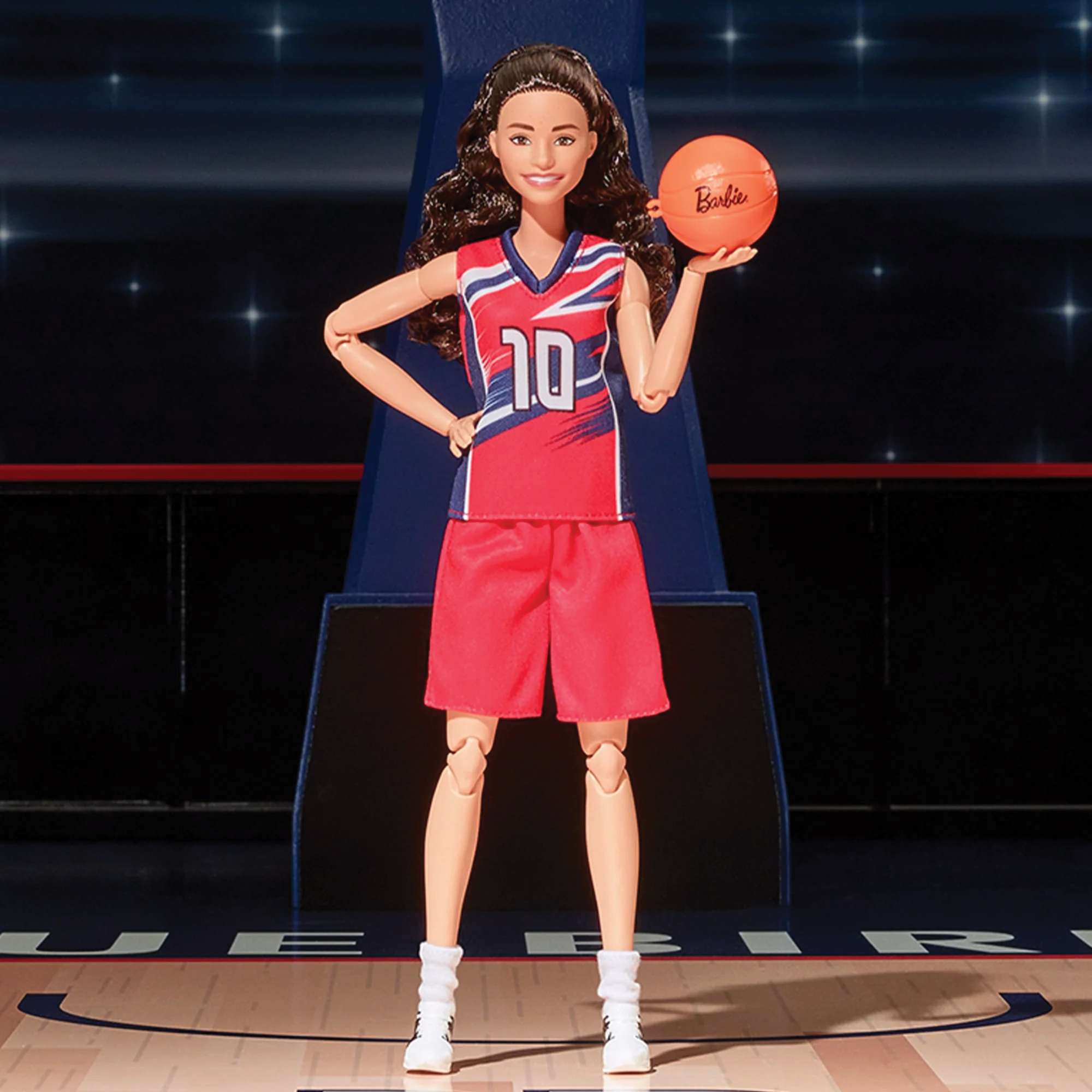 The new 'Sue Bird' Barbie doll poses with a basketball