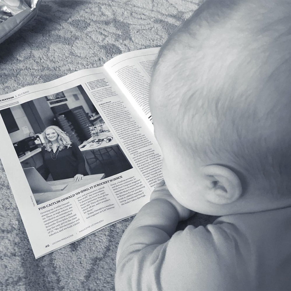 Baby-Q reading up on his mama in UConn Magazine