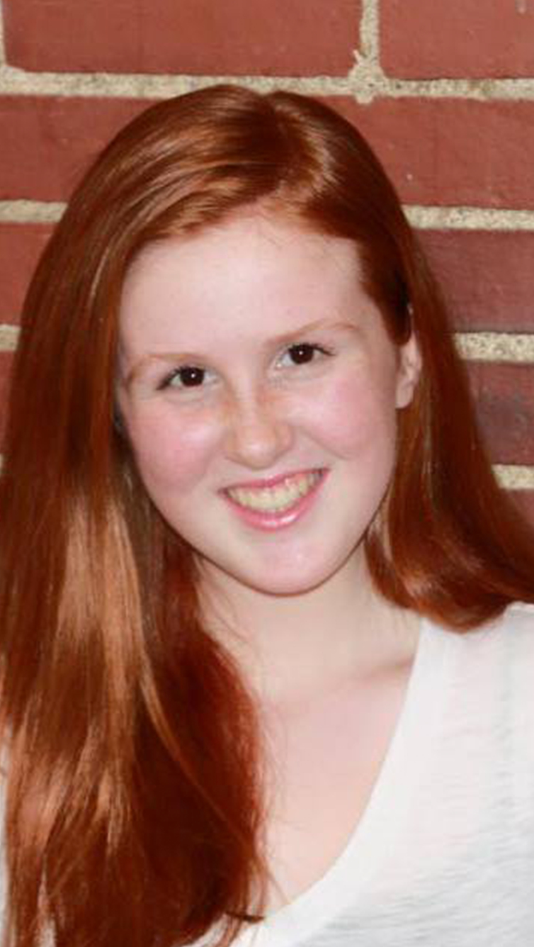 young woman with long loose hair and white tee