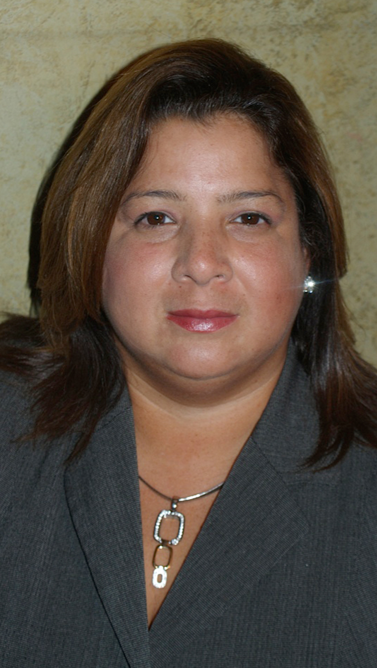 woman in suit and large statement necklace and jeweled earrings