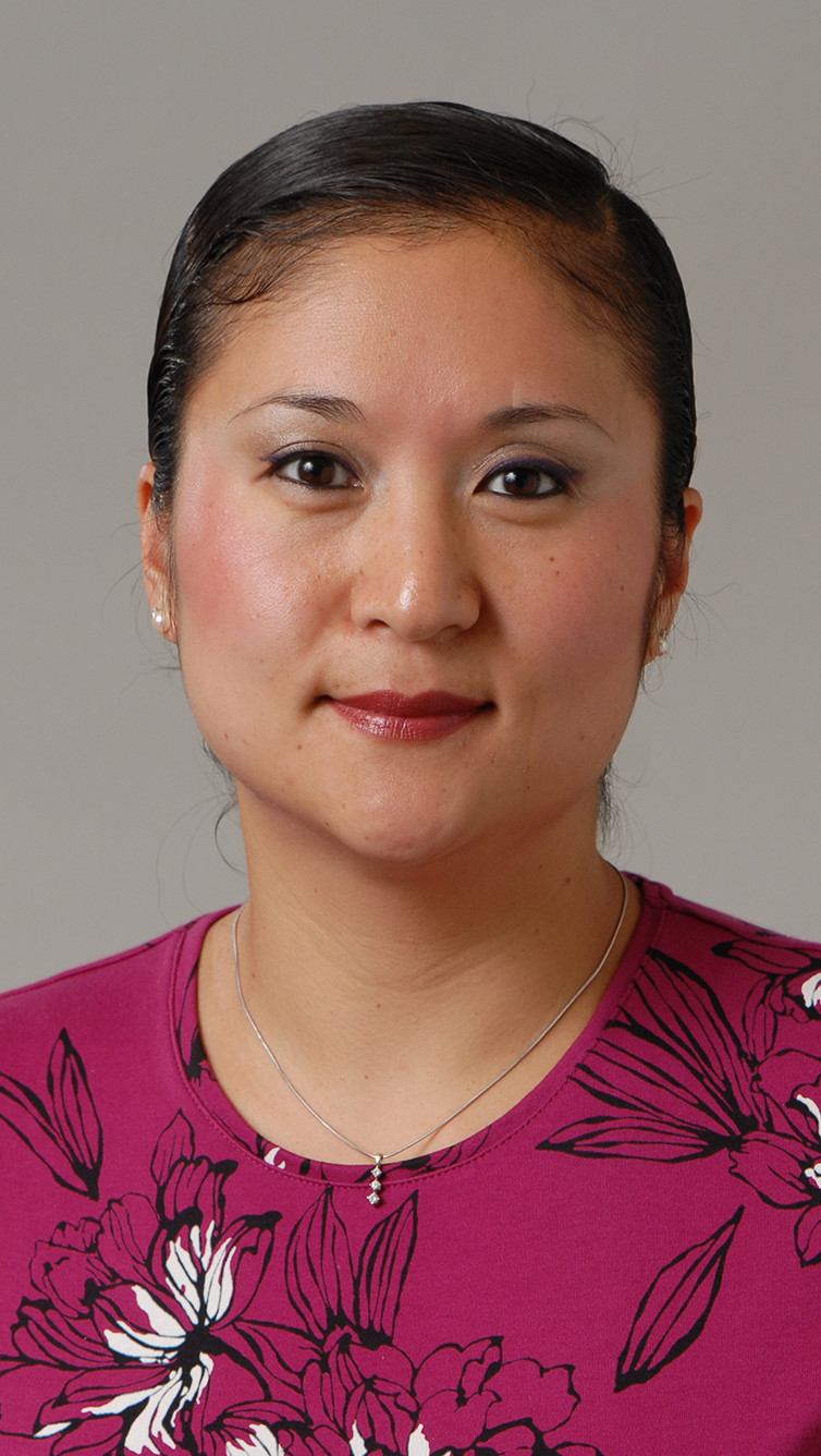 woman in pink floral top and light makeup