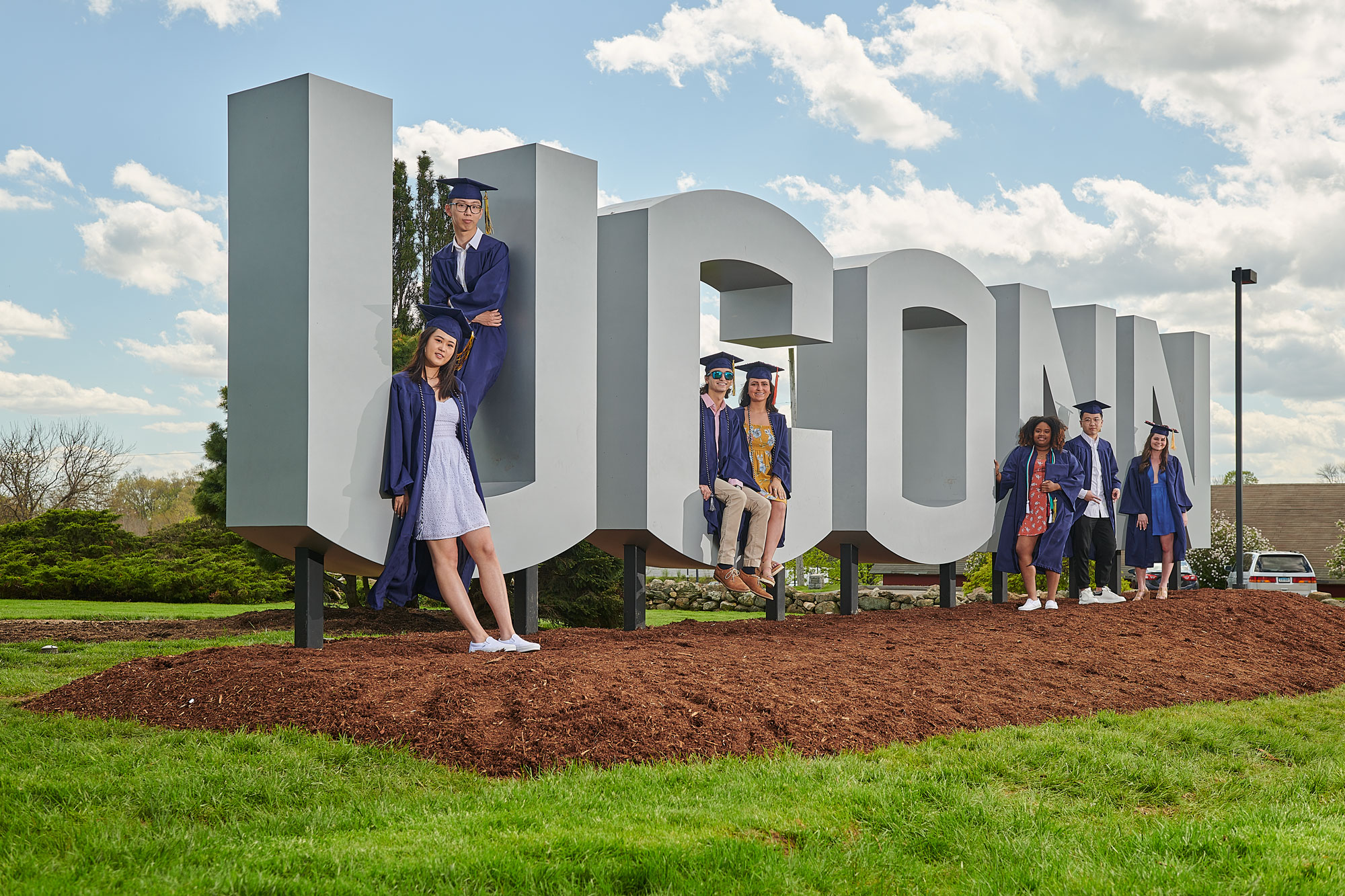 Soon to be graduats pose with the new UConn sign  along RT. 195 near W lot on May 8, 2019. From left are Kailin Lu '19 (CLAS), Kai Lu '19 (CLAS), Harun Malik '19 (CLAS), Carley Corbo '19 (ENG), Sidayah Dawson '19 (CLAS), Zhenhao Zhang '19 (CLAS), and Debra Peel '19 (CAHNR). 