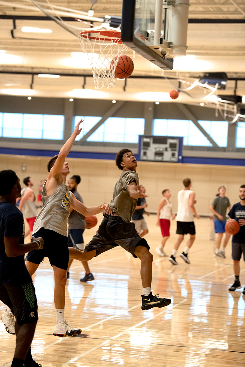 pleople playing basketball on the new rec center court