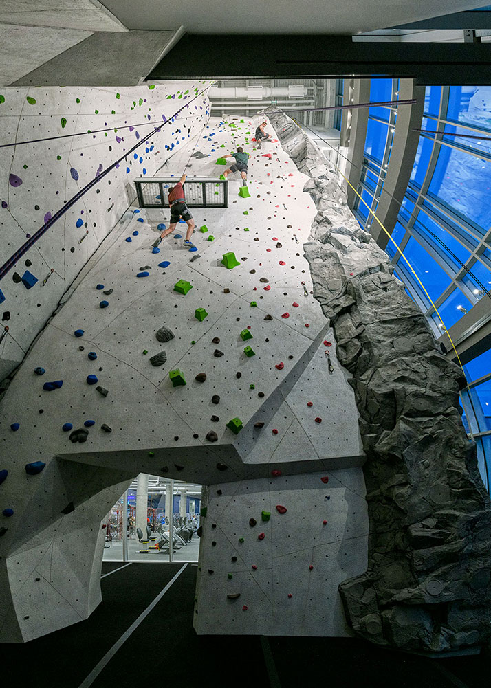 Multistory UConn Rec Center Rock wall surrounded by multisotry windows with campus views