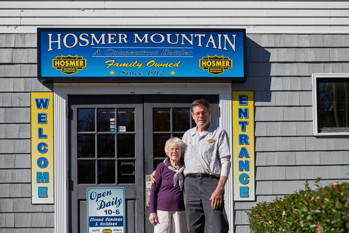 Bill Potvin '67 (CAHNR) with his mother at the Hosmer Mountain Bottling Company in retail store in Willimantic