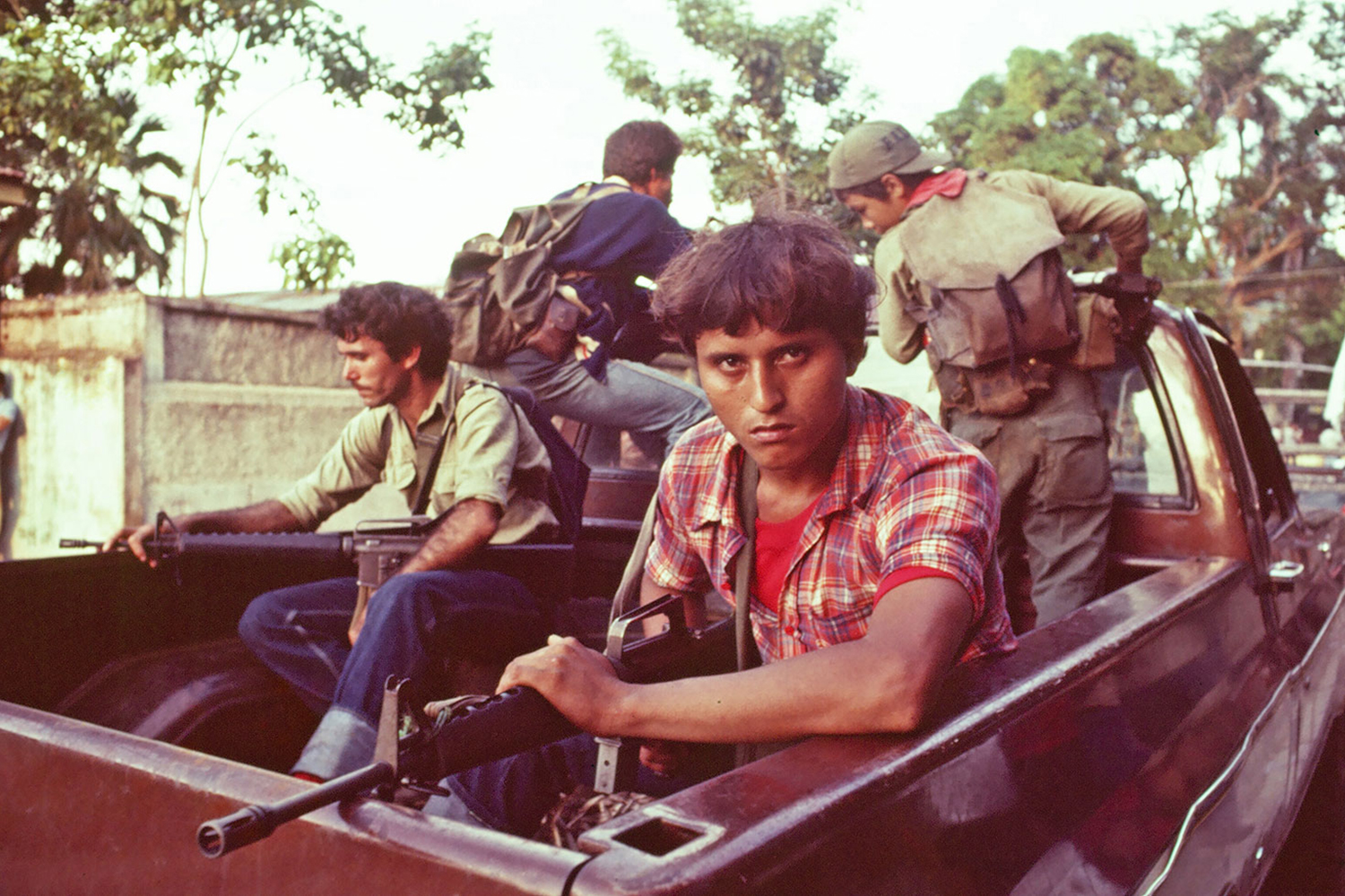 Leftist rebels enter the city of Chinameca, El Salvador, aboard a pickup, 1983.