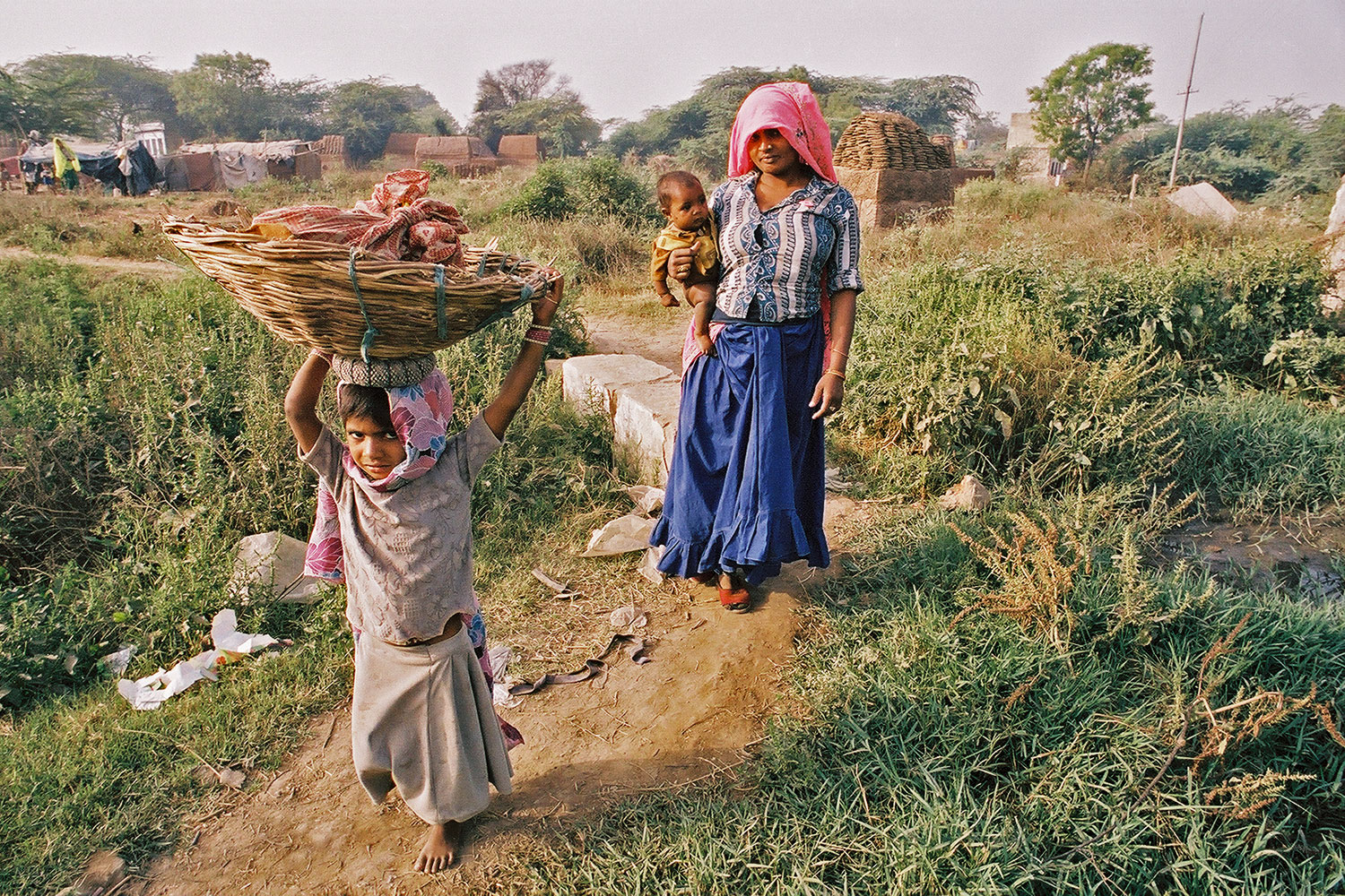 Dalit (Untouchable) girl with mother and infant sibling in Haryana State, India, 2004.