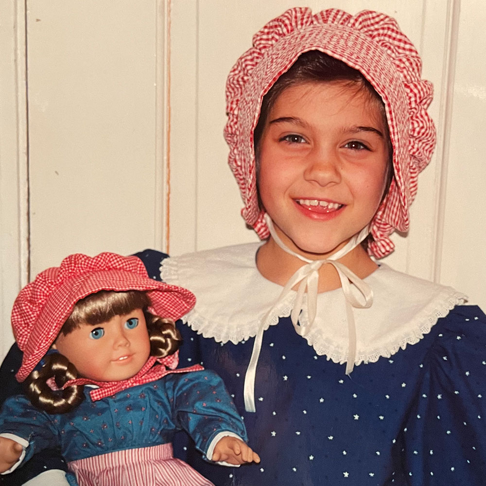 UConn Magazine's art director Christa Yung with her Kirsten doll, circa 2000