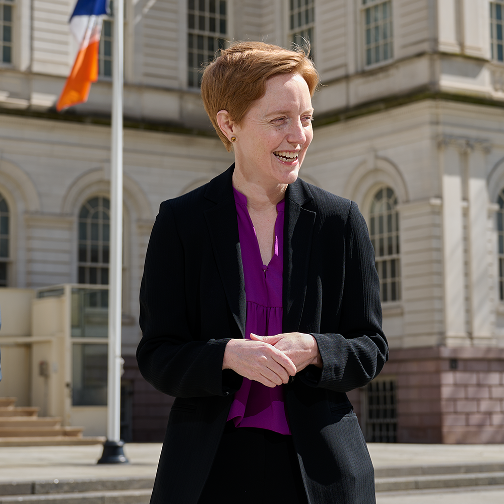 Karen Dahl '99 (CLAS) speaking with AmeriCorps leaders outside New York City Hall in April.