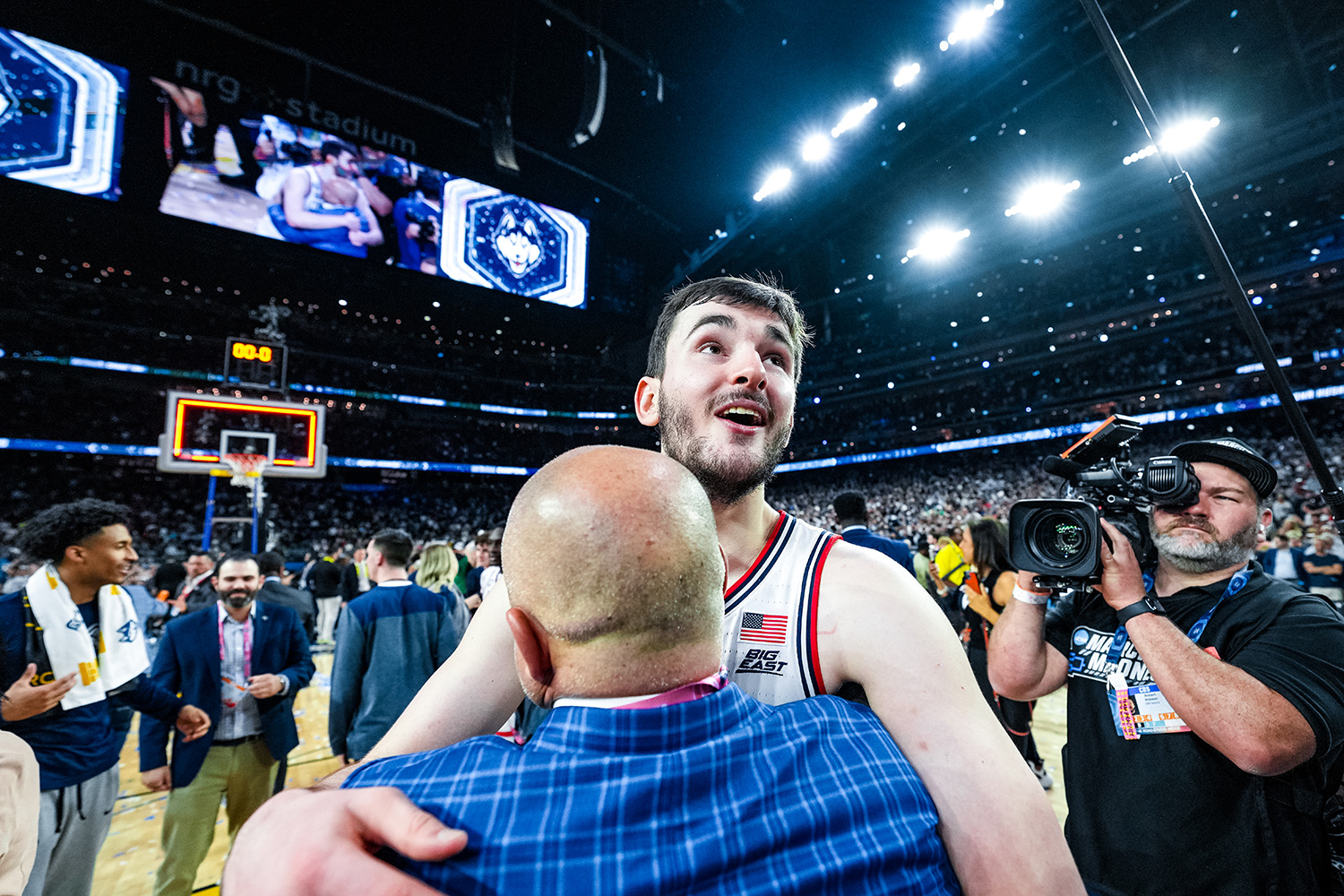 Alex Karaban and AD David Benedict embrace after an emotional win