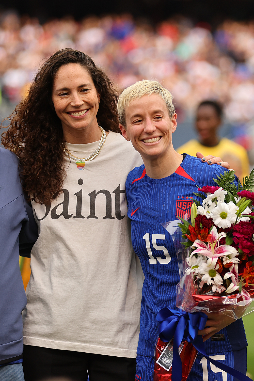 CHICAGO, ILLINOIS - SEPTEMBER 24: Megan Rapinoe #15 of the United States' and her fianceÌ Sue Bird laugh prior to the game between the United States and South Africa at Soldier Field on September 24, 2023 in Chicago, Illinois.