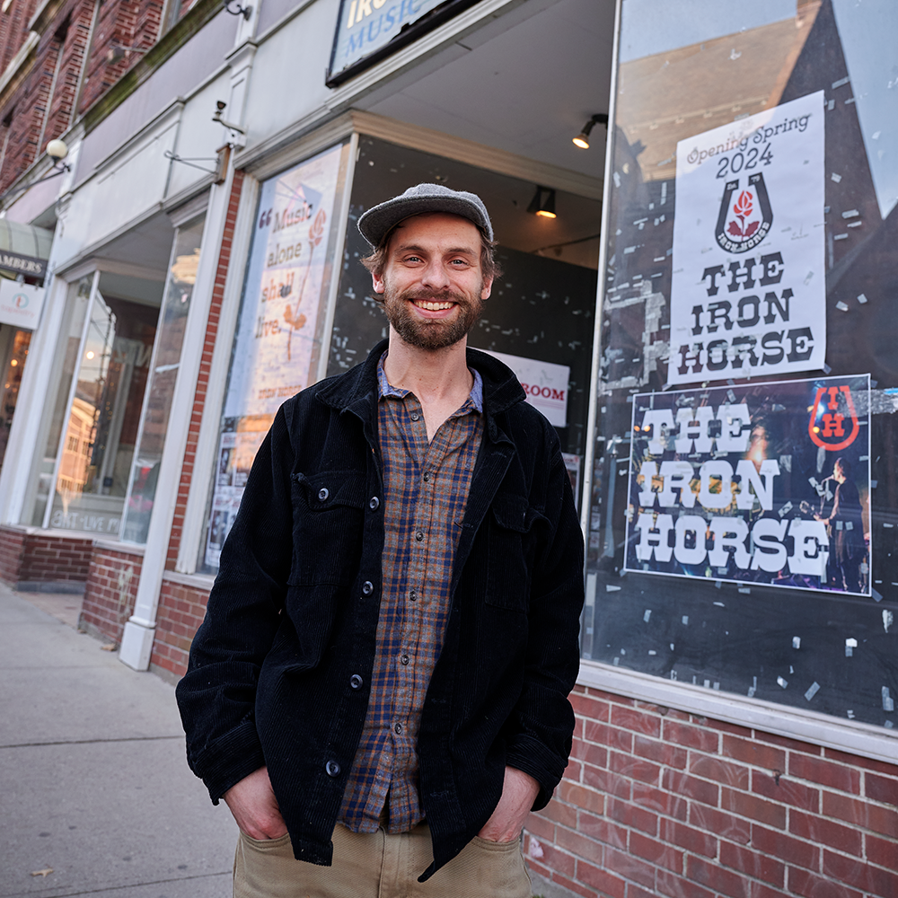 Freeman, of the UConn band Poor Old Shine, stands in front of the Iron Horse Music Hall