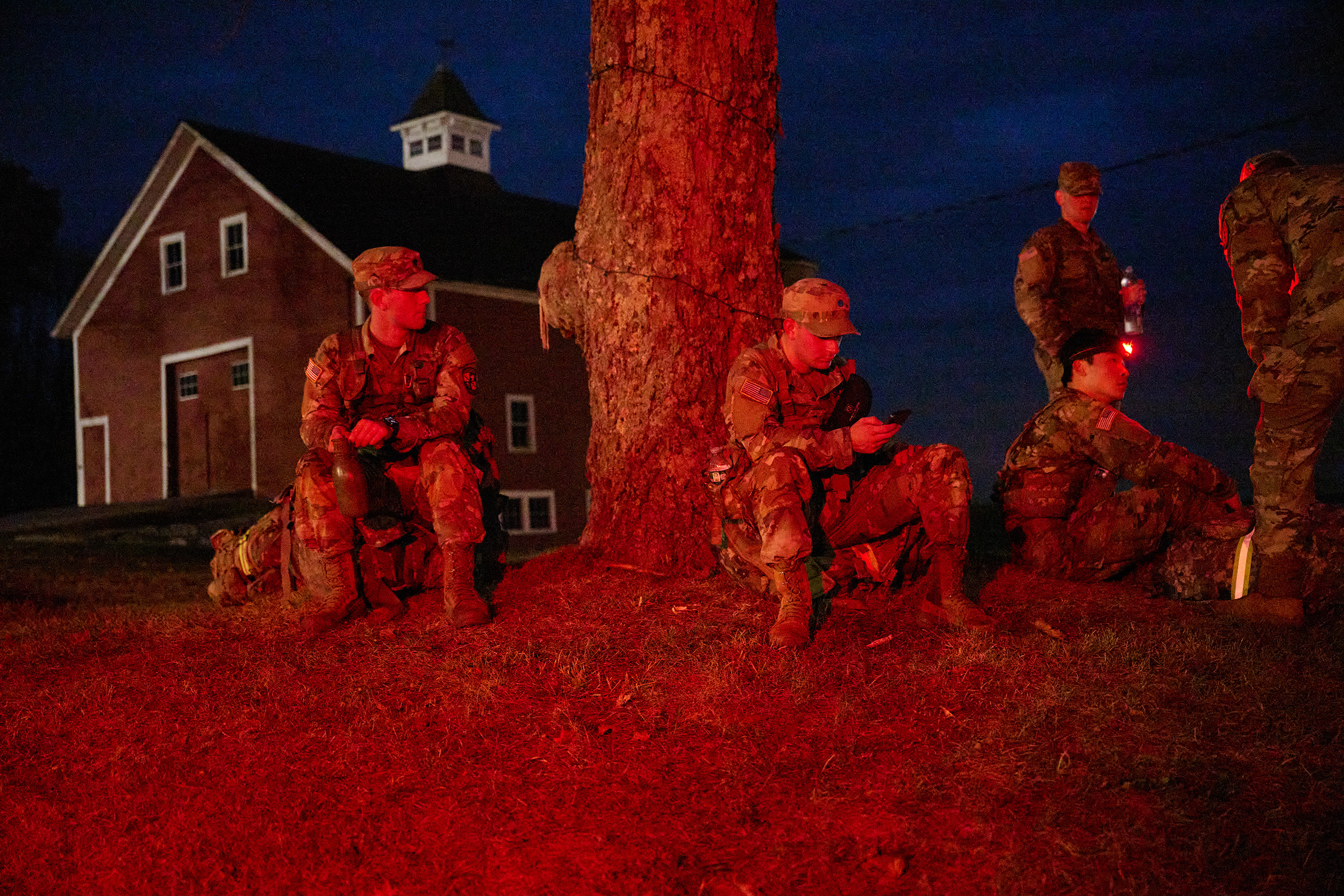 A group of uniformed ROTC students, two standing and three sitting, by a tree at Horsebarn Hill.