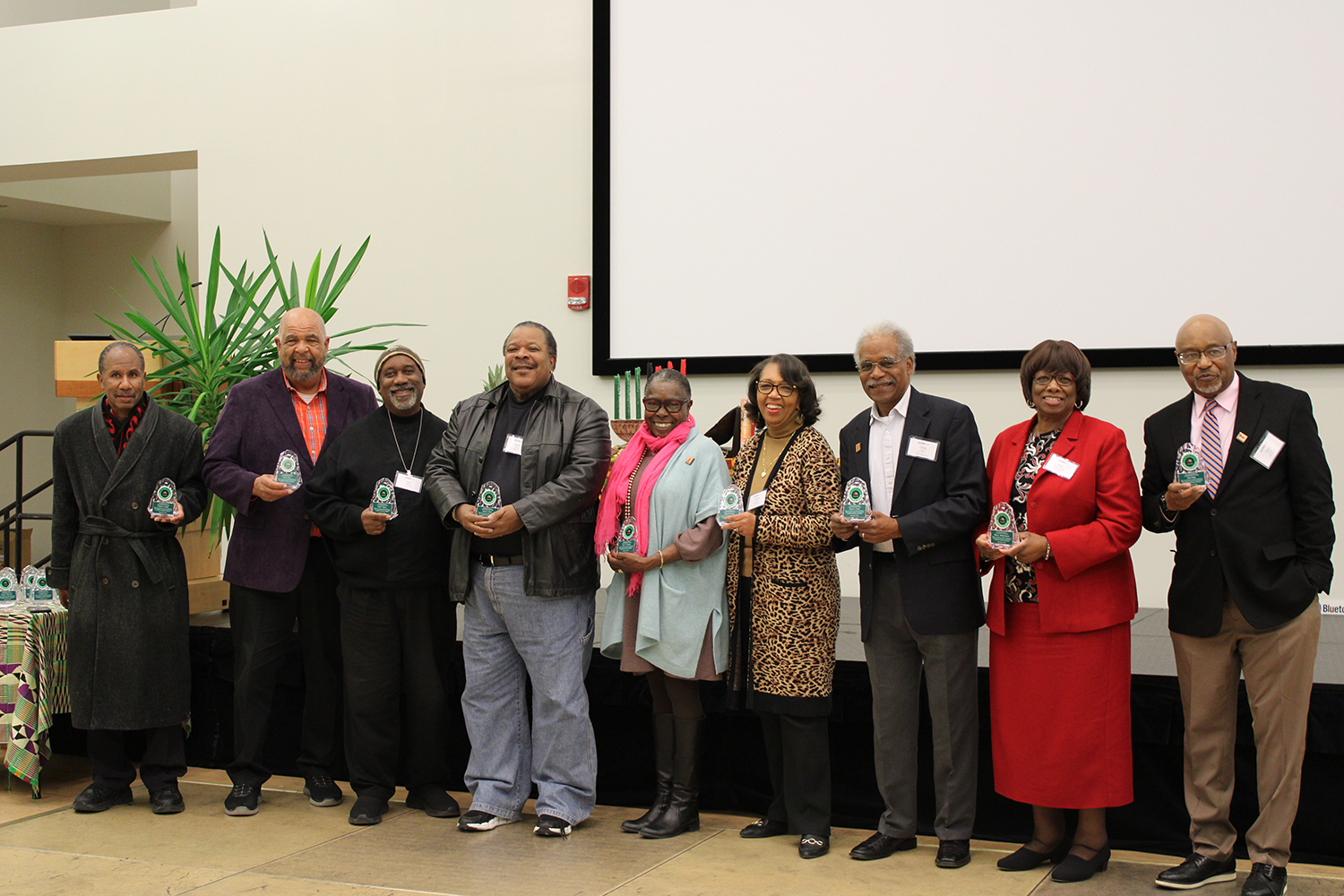 Group Picture 9 members of the 1974 Black Student Sit-In at the Wilbur Cross Library stand together at the 50th anniversary event.