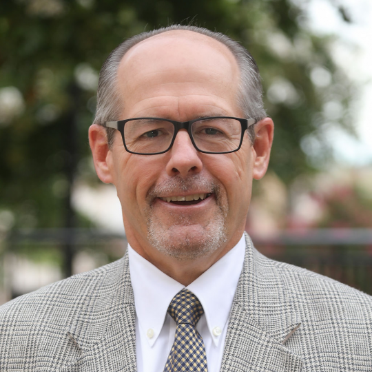 Kurt Telford in beige suit and tie