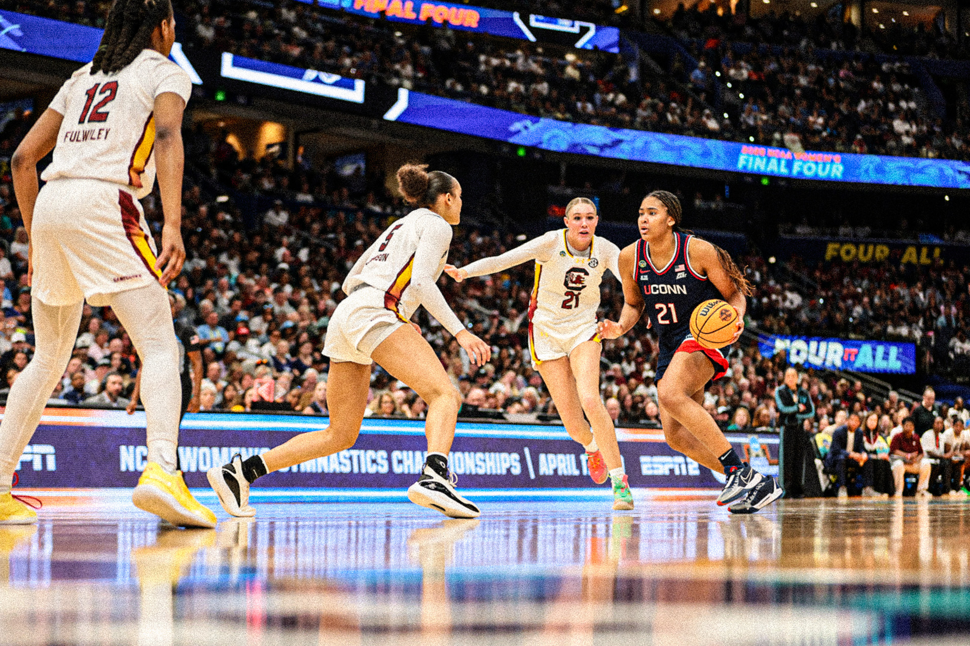 ME301158 (1)-sized Sarah Strong dribbles the ball up the court while being guarded by two South Carolina players.
