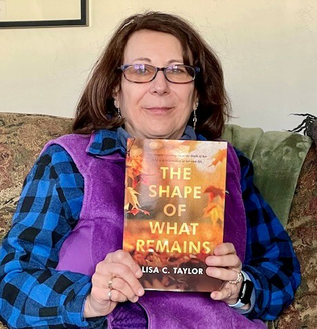 Lisa C. Taylor shows off her book, "The Shape of What Remains".