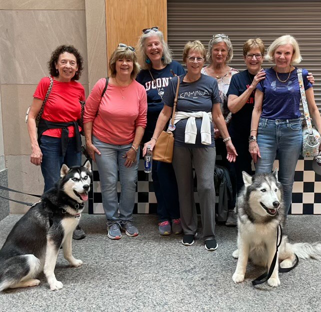 Seven friends who met as freshmen in September 1970 Maureen (Fisk) Anderson, Michele Merusi, Barbara Burns, Patricia (Brennan) Bacon, Lynn Lane, Jamie Lang-Rodean, and Kathleen (McBrien) Insler pose in the Student Union with Jonathan XIV and Jonathan XV