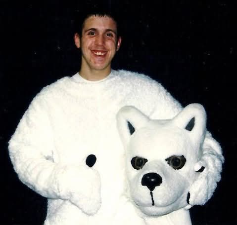 Paul poses inside vintage UConn Husky mascot costume