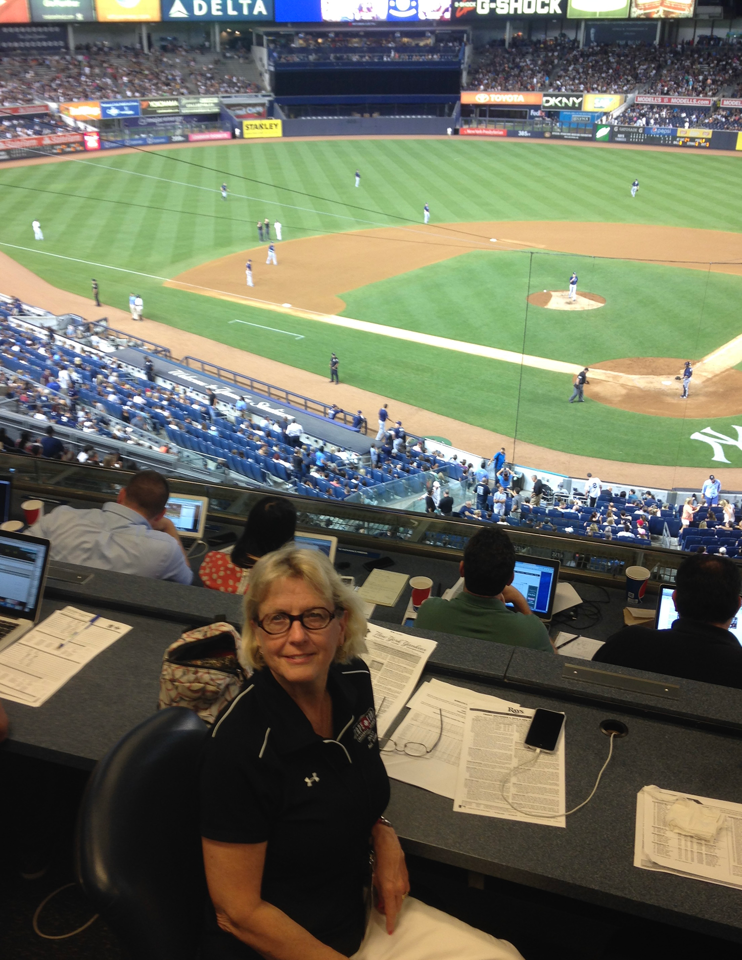 Judy Scarafile in the Yankee Stadium press box on Sept. 4, 2015 with the field behind her