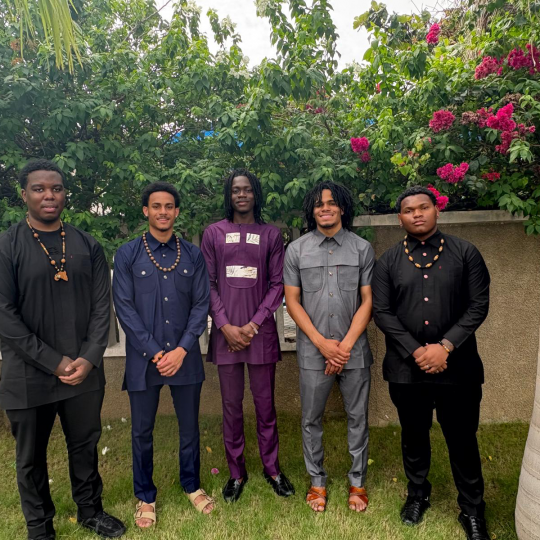 Christian Miller smiles pleasantly with four other gentleman, in Ghana.