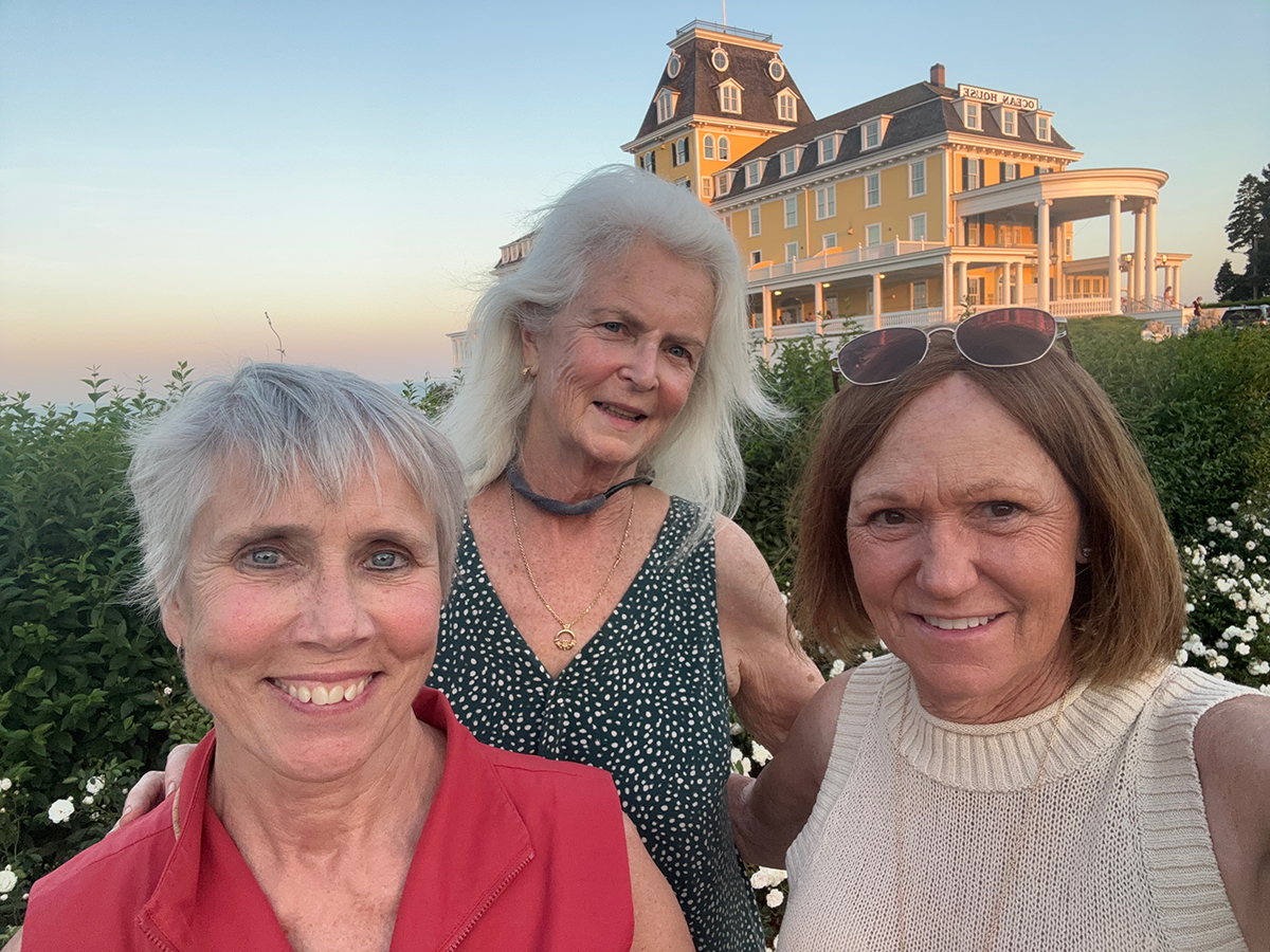 Former dormmates smile for the camera in front of a gorgeous view in Rhode Island.